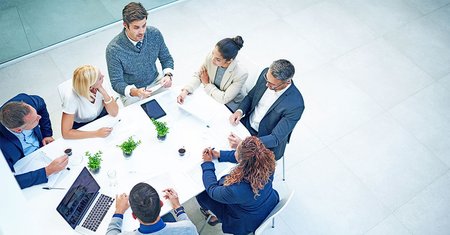 group of business people sitting at round table
